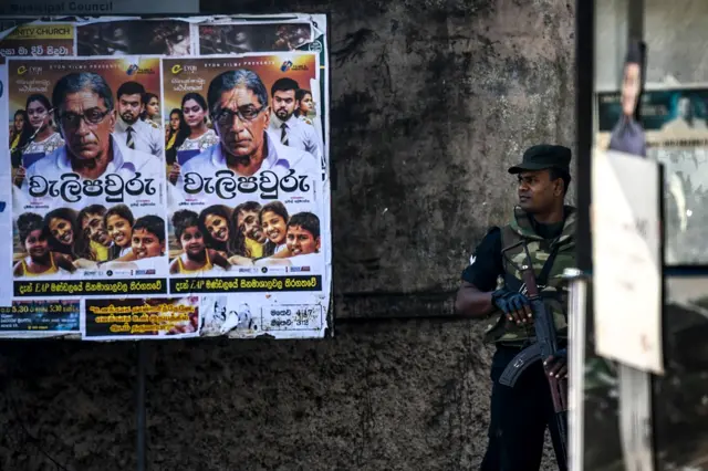 A soldier stands guard on a street in the Sri Lankan capital, Colombo