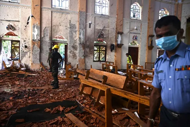 Torn up floor and pews in the church