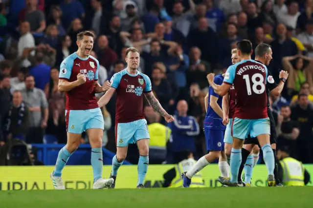 Burnley players celebrate the point