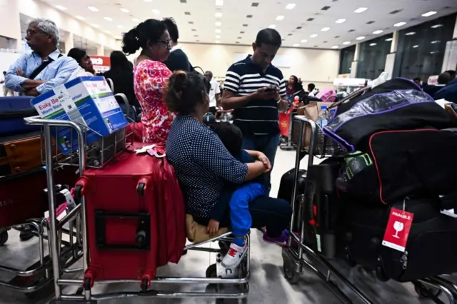 Passengers wait at Bandaranaike International Airport in Katunayake, Sri Lanka