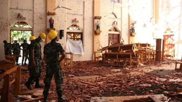 Officials inspect the damage caused by a bomb at St Sebastian's Church in Negombo