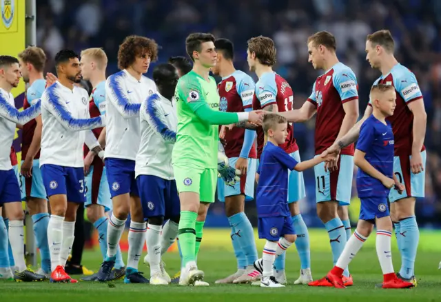 Cheslea and Burnley players shake hands before the match