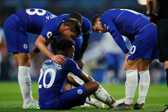 Injured Callum Hudson-Odoi surrounded by concerned team-mates