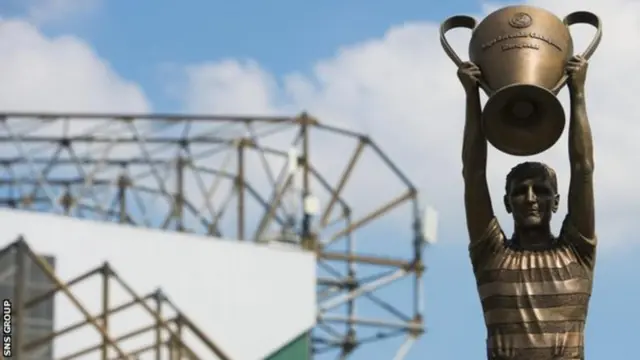 A statue of Billy McNeill with the European Cup stands outside Celtic Park