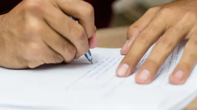 Person writing on paper