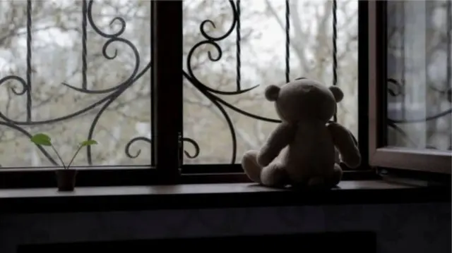 Teddy in window