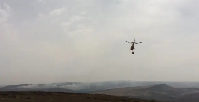 Helicopter dropping water