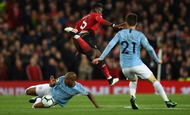 Fernandinho tackles Paul Pogba