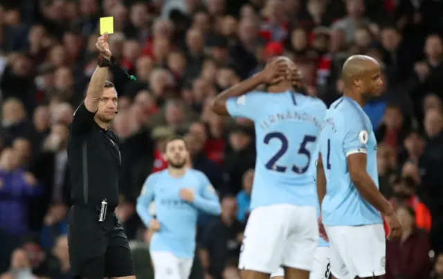 Vincent Kompany is shown a yellow card