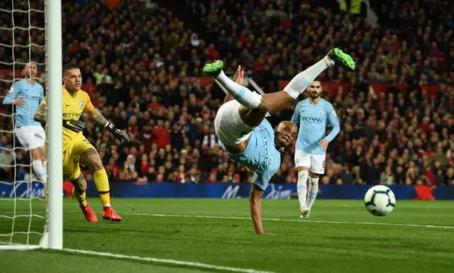 Vincent Kompany attempts a clearance