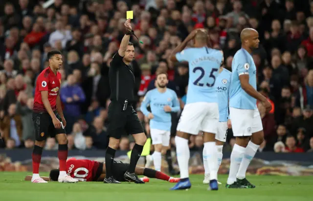 Andre Mariner books Vincent Kompany for foul on Marcus Rashford