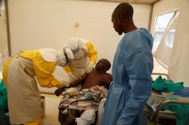 Medical stuff and an Ebola survivor treat Ebola patient Ibrahim Mupalalo inside the Biosecure Emergency Care Unit (CUBE) at the ALIMA (The Alliance for International Medical Action) Ebola treatment centre in Beni, in the Democratic Republic of Congo, March 31, 2019. Picture taken March 31, 2019.