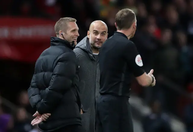 Pep Guardiola in discussion with the officials