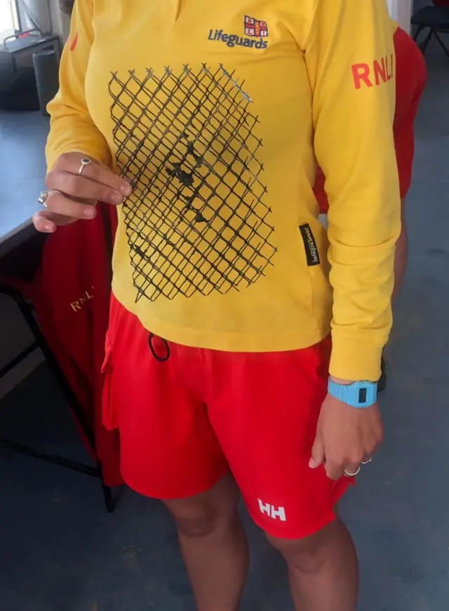 Lifeguard holding part of BBQ