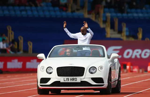 Mo Farah waves goodbye from a car