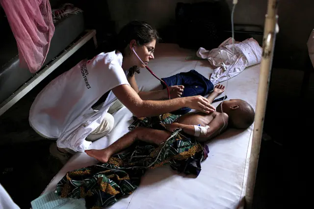 Chris Lenzen, a German medical doctor, checks on a sick patient on December 10, 2005 in Dubie, Katanga Province in Congo, Democratic Republic of the Congo.