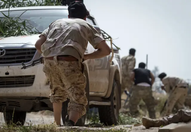 Fighters loyal to the internationally recognised Government of National Accord (GNA) get into position during clashes with forces loyal to strongman Khalifa Haftar south of the capital Tripoli"s suburb of Ain Zara, on April 25, 2019.