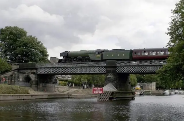 Scotsman traversing Scarborough Bridge in York