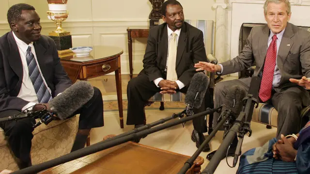 George W Bush (R), then US president, speaks with Alfred Taban from Sudan (L) and Dr Reginald Matchaba-Hove and other recipients of the National Endowment for Democracy Award on 27 June 2006 at the White House in Washington DC, the US