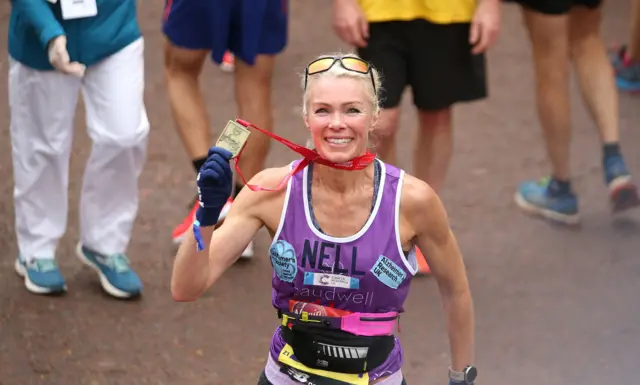 Nell McAndrew holds up her London Marathon medal