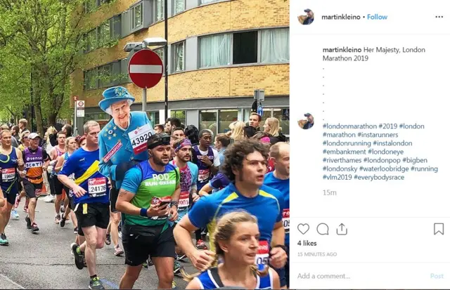 cardboard cutout of the Queen among runners racing in the London Marathon