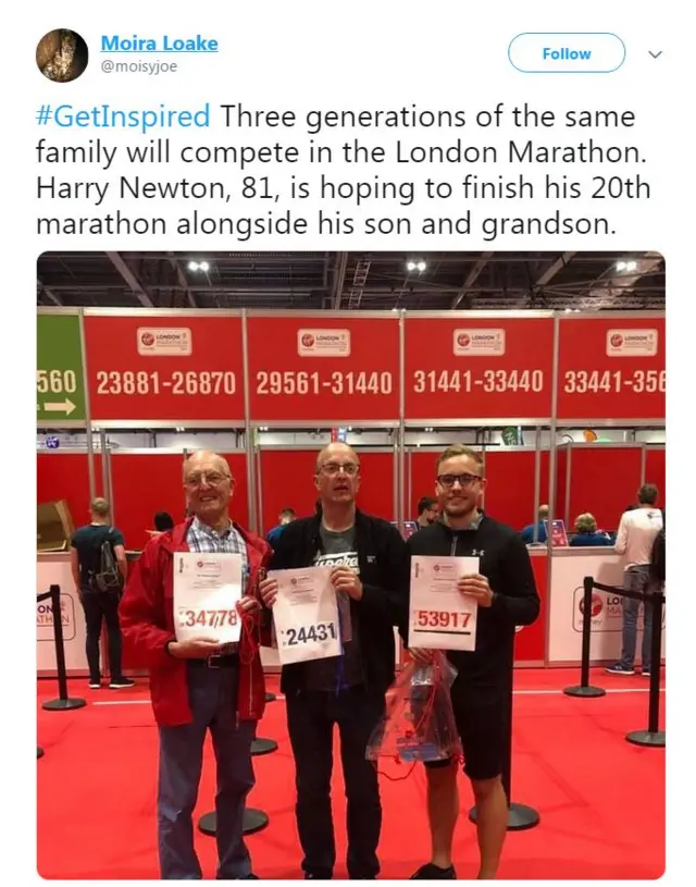 Father, son and grandson all standing holding their marathon number the day before the race