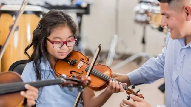 Child learning violin