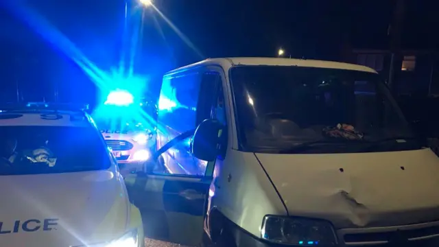 A white van and two police cars