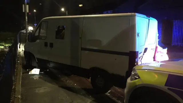 White van and a police car