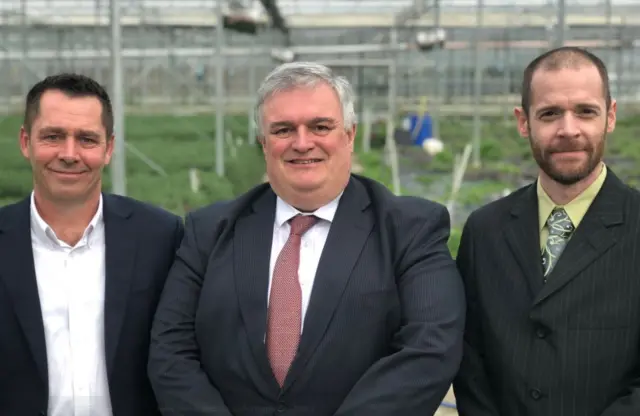 Men in greenhouse