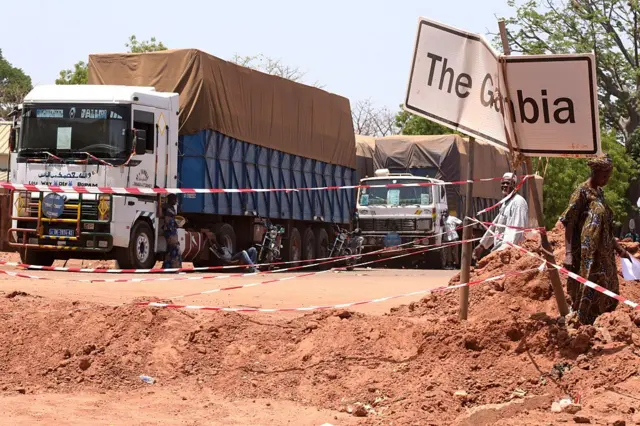 Truckers stop along the Senegalese-Gambia border town of Keur Ayip on May 9, 2016