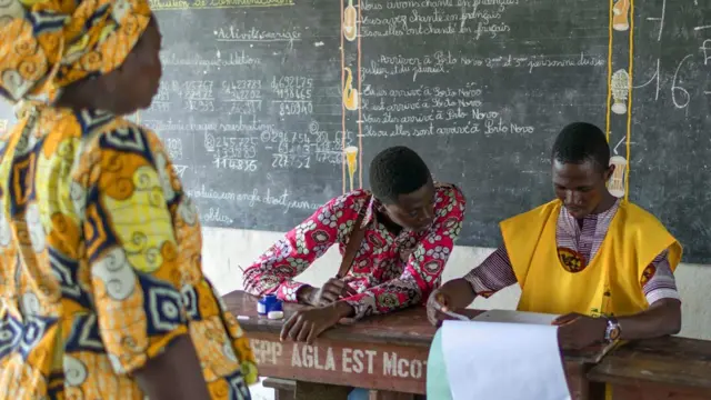 A Beninese voter arrives to cast her ballot on Sunday 28 April 2019.