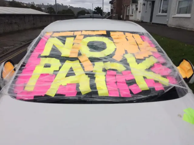 Car covered in Post-it notes