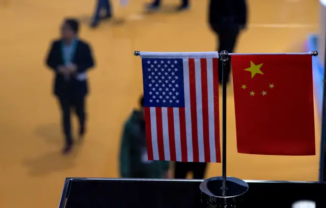 This picture taken on November 6, 2018 shows a Chinese and US flag at a booth during the first China International Import Expo (CIIE) in Shanghai.