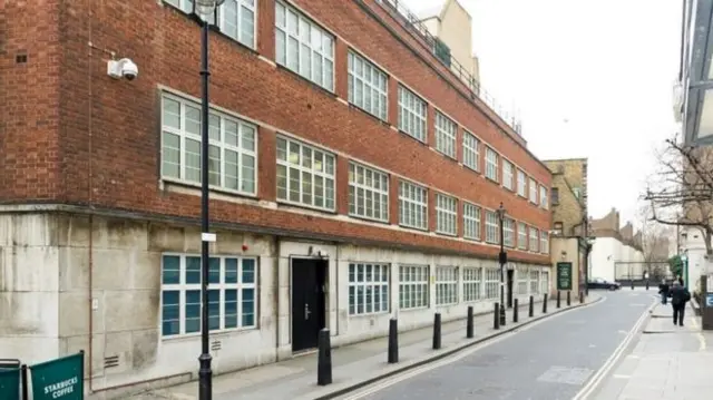 The unremarkable office block is sandwiched between a Starbucks and a pub