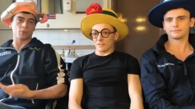 Three dancers wears hats