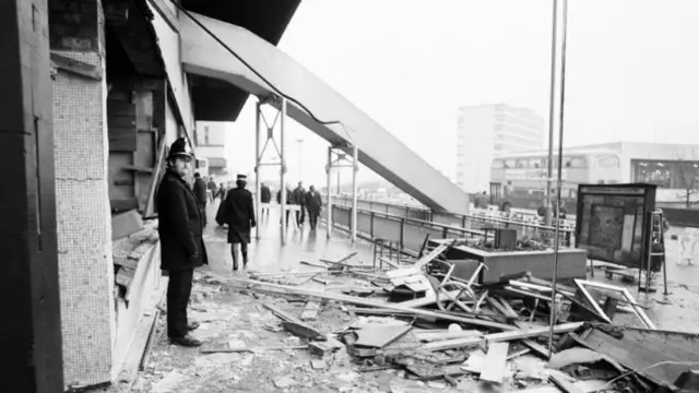 A police officer outside a devastated pub the morning after the blast