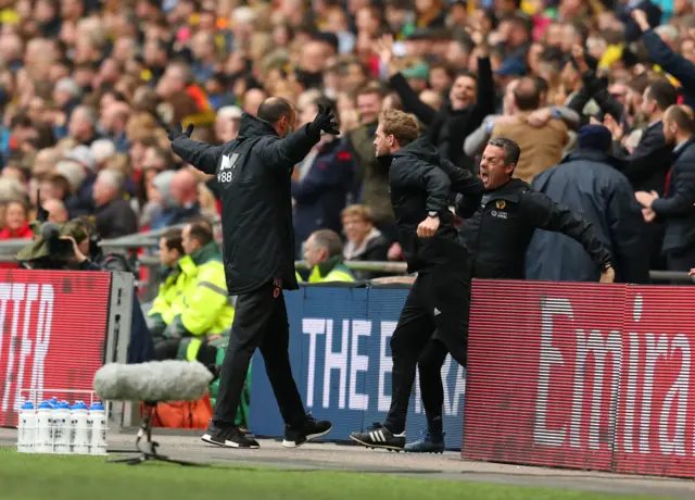 Nuno Espirito Santo, Manager of Wolverhampton Wanderers (L) and the team bench celebrate as Matt Doherty scores his team"s first goal with team mates during the FA Cup Semi Final match between Watford and Wolverhampton Wanderers