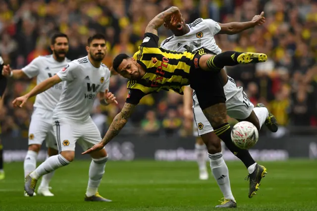 French defender Willy Boly (R) vies with Watford's English striker Andre Gray (C) during the English FA Cup semi-final football match between Watford and Wolverhampton Wanderers