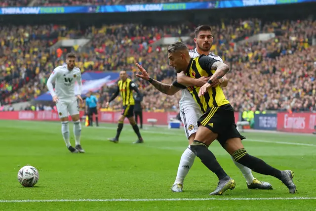 Roberto Pereyra of Watford tangles with Ruben Neves of Wolverhampton Wanderers