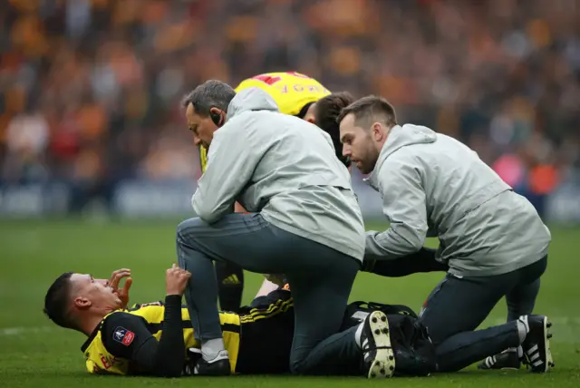 Jose Holebas receives medical attention after sustaining an injury