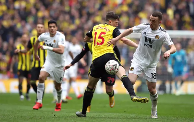 Craig Cathcart is booked for fouling Diogo Jota