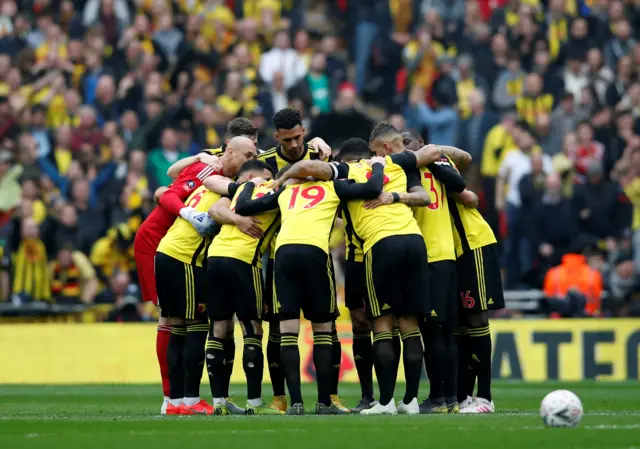 Watford players huddle before the match