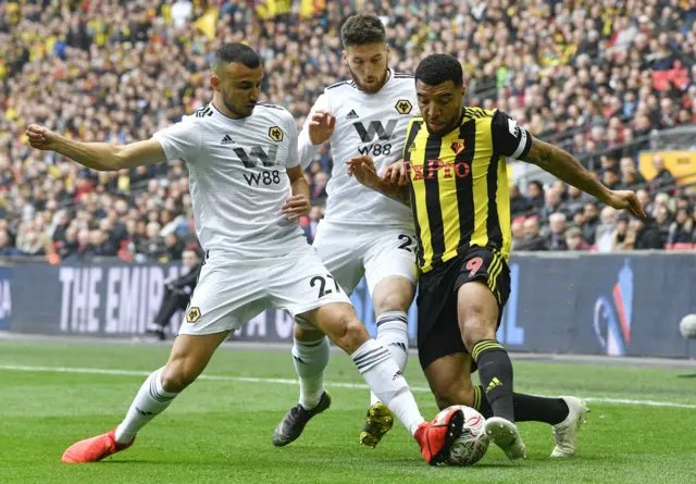 Troy Deeny (R) in action against Wolverhampton Wanderers' Matt Doherty (C) and Romain Saiss