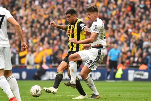 Leander Dendoncker (R) fouls Watford"s English striker Troy Deeney for a penalty to Watford