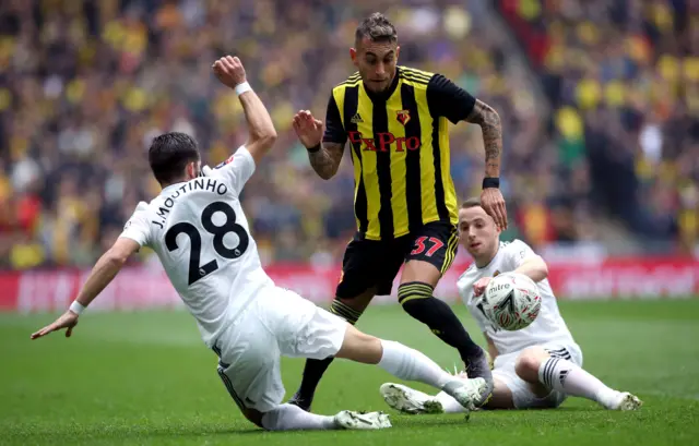 Roberto Pereyra (centre) battles for the ball with Wolverhampton Wanderers" Joao Moutinho (left) and Diogo Jota