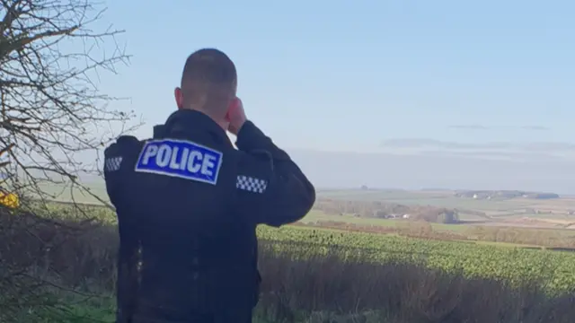 A police officer looking out over the landscape