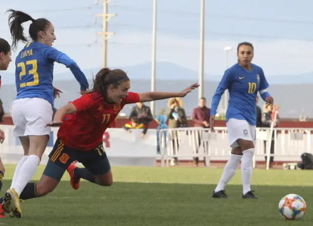 Spain scorer Alexia Putellas (right) is brought down by Brazil's Luana