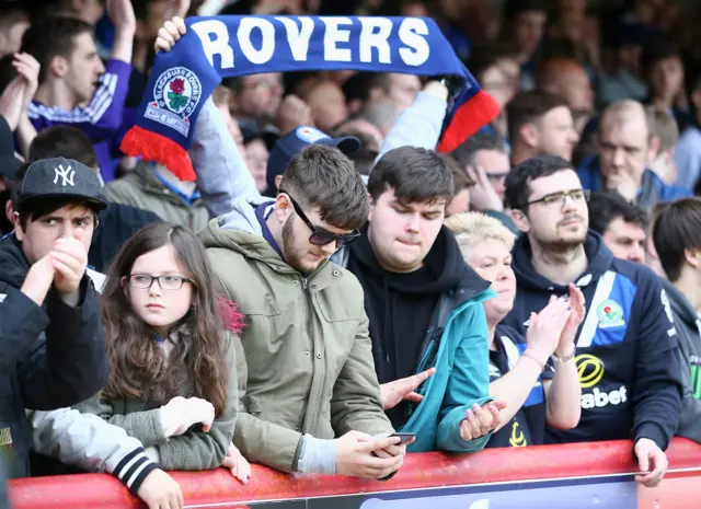 Blackburn fan looking at his phone