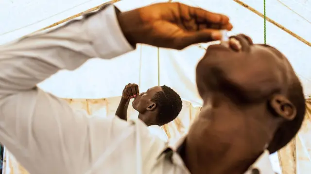 Man taking cholera vaccine